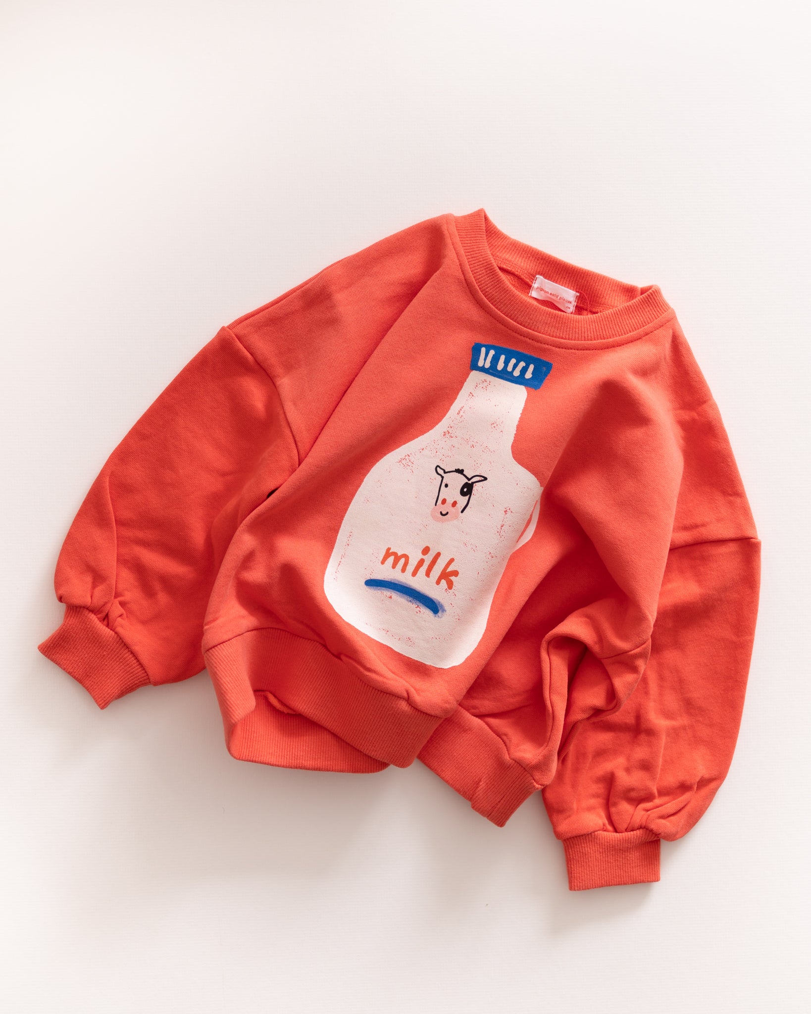 Red sweatshirt with a milk carton graphic on a white background