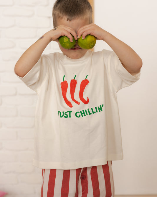 toddler wearing cream chilli graphic tee with just chillin text