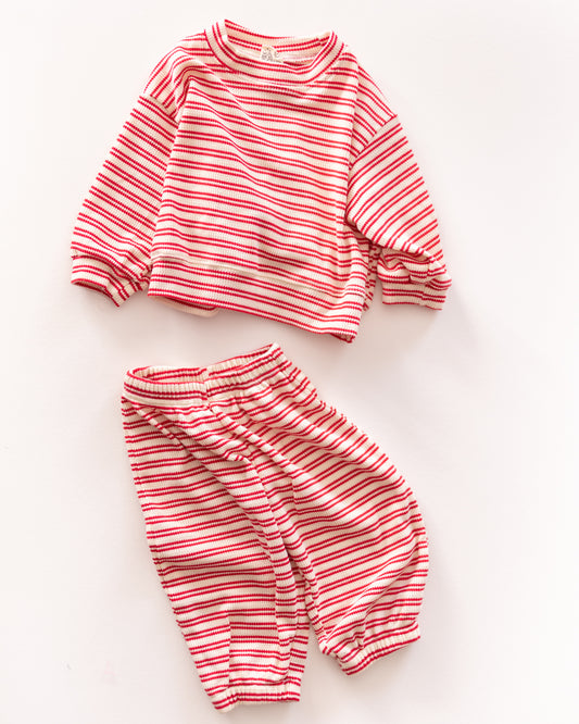 Red and white striped children's outfit on a light background
