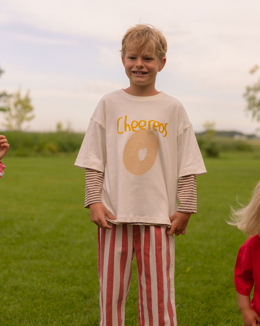 little boy wearing white graphic tee from pigeonsaid please